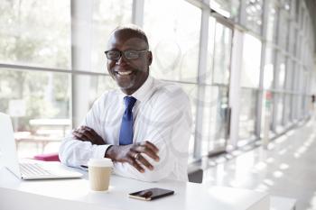 Portrait of a black businessman sitting at a desk