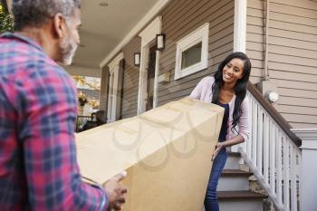 Couple Carrying Big Box Purchase Into House