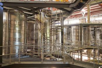 Spiral stairs in a modern winemaking facility interior