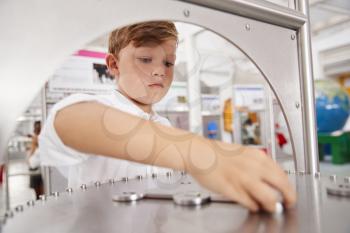 Schoolboy taking part in a science test at a science centre