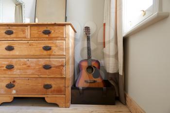 Room Interior With Chest Of Drawers And Acoustic Guitar In Contemporary Bedroom