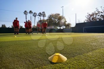 Womens Football Team Training For Soccer Match On Outdoor Astro Turf Pitch