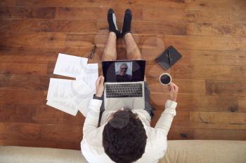 Businessman Wearing Loungewear And Shirt And Tie For Video Call On Laptop Working From Home