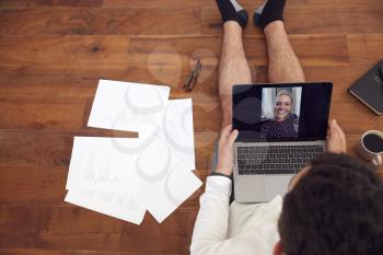 Businessman Wearing Loungewear And Shirt And Tie For Video Call On Laptop Working From Home