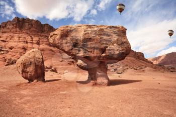 The Monument Valley. Famous red sandstone monoliths, fly over them colorful balloons