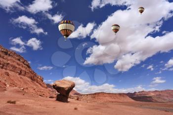 The Monument Valley. Famous red sandstone monoliths, fly over them colorful balloons