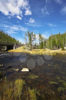 The picturesque bridge through the multi-coloured river Gibbons in Yellowstone national park