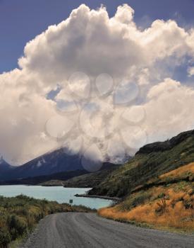 National Park in Chilean Patagonia - Torres del Paine. Gravel road bends along the shores of Lake Pehoe