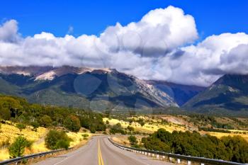 Patagonia. The longest road the Ruta 40 passes in Argentina among lakes and fields. Magnificent cumulus clouds decorate mountains of the Southern Andes