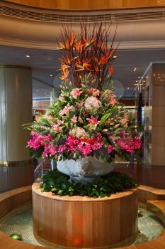 Huge magnificent flower bed - a vase decorate a hall of expensive hotel
