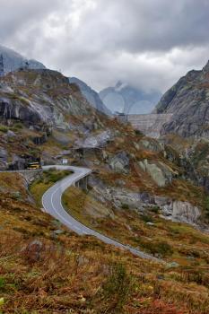 
Dam and asphalt highway in Switzerland mountains

