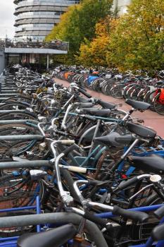 Parking a bike in Amsterdam. Cloudy Autumn Day