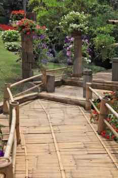 Magnificent huge park on island Madiera. A wooden path among flower beds
