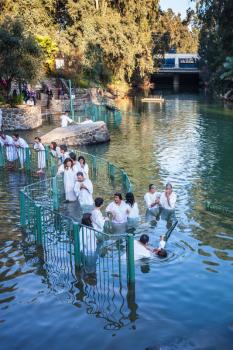 YARDENIT, ISRAEL - JANUARY 21, 2012: Christian pilgrims enter Jordan River waters. They make  baptism ceremony in honor of Jesus Christ's baptism here