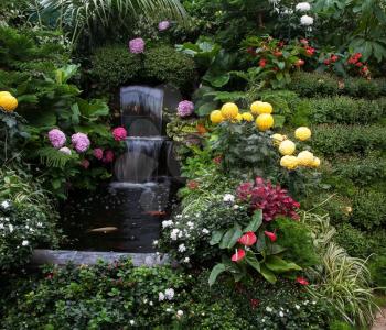 Luxury three-stage Fountain Mirror stream among the flowers. Butchart Garden Park on Vancouver Island, Canada
