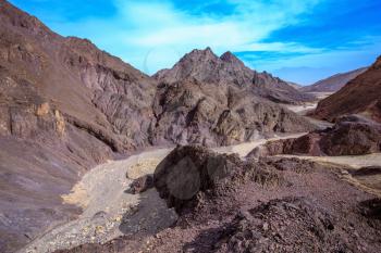 Walking road to the Pillars of Amram. Multi-colored mountains of Eilat, Israel. Warm day in January