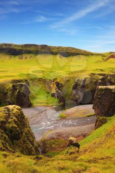 Neverland Iceland. Picturesque rocks with yellowed grass around the canyon Fjadrargljufur