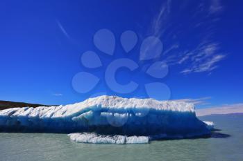  White-blue huge icebergs float near a ship board. Excursion by tourist motor ship on Vyedm's lake. Ices and sun of Patagonia