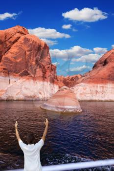 The elderly woman in white aft boats is delighted with the nature. The artificial lake Powell on the river Colorado, USA