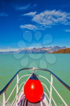 Unique lake Viedma in Argentine Patagonia.  The lake is surrounded by mountains. Big boat for tourists