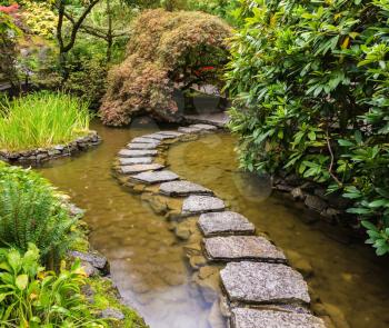 Amazingly beautiful decorative private garden in western Canada Butchart Gardens. The track of the stones in the Japanese part of the garden