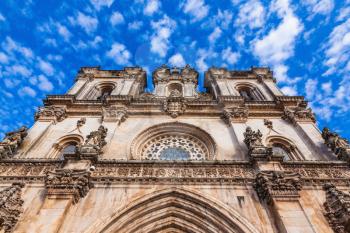Portugal. Clock on the facade of the Catholic Cathedral of Alcobaça.