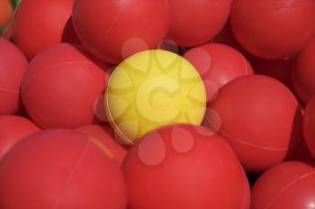 Royalty Free Photo of Red Balls and One Yellow One