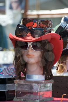 Royalty Free Photo of a Mannequin Head With a Red Hat and Sunglasses