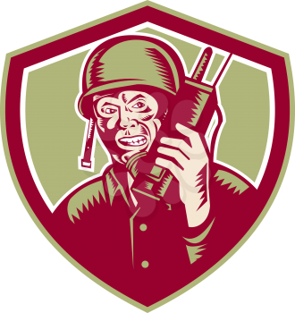 Illustration of a World War two American soldier serviceman talking on field radio walkie-talkie viewed from front set inside crest shield on isolated background done in retro woodcut style. 