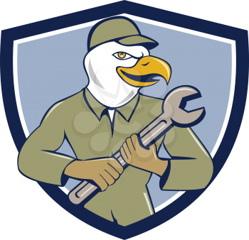 Illustration of a american bald eagle mechanic holding spanner looking to the side viewed from front set inside shield crest on isolated background done in cartoon style. 