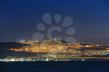 The shore of Lake Kinneret and the city of Tiberias at night