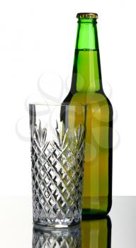 Bottle of lager beer from green glass, isolated on a white background.