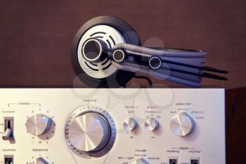 Audio Stereo Headphones on the top of Vintage Amplifier Front View