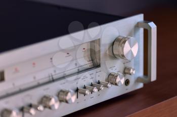 Vintage Stereo Receiver Standing on the Wooden Sideboard, Side View
