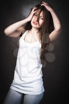 Portrait of a young brunette lady on white background