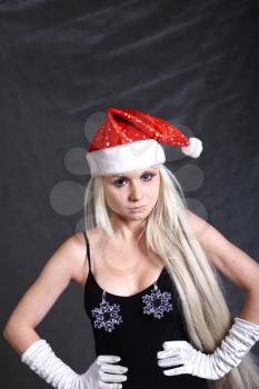 A Mrs. Santa dressed girl  studio shooting on gray background