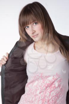 A blond model in the studio wearing a black jacket