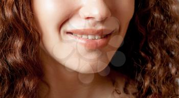 Close up shoot of young beautiful girl with perfect skin: makeup mouth zone. Smiling Lips.