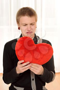 frustrated teenager  with a teddy heart in hand