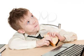 thoughtful boy eating a sandwich with his tie isolated on white background