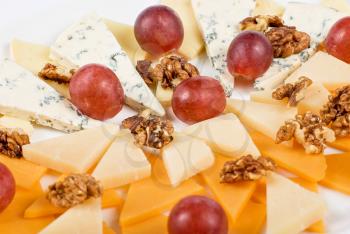 Royalty Free Photo of a Variety of Cheese and Grapes
