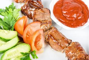Royalty Free Photo of Fried Kebab Meat With Vegetables and Sauce
