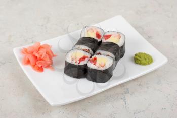 Sushi rolls made of crab meat, cheese, and tomato