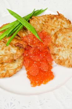 pancakes with red caviar and green onion closeup dish
