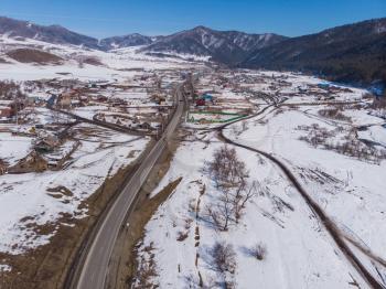 Aerial view of a road in winter landscape of Altai mountains