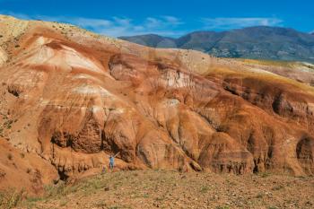 Woman in valley of Mars landscapes in the Altai Mountains, Kyzyl Chin, Siberia, Russia