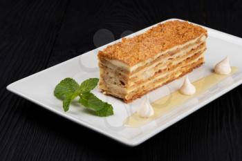 Esterhazy traditional cake with mint on black wooden background