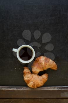 coffee with croissant at board