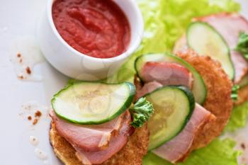 pancakes with ham and cucumber with tomato sauce and lettuce