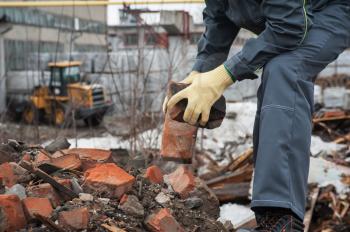 worker takes down blockages of broken bricks